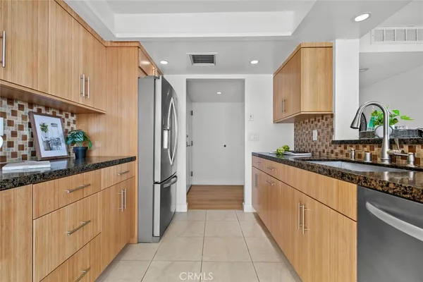 a kitchen with granite countertop a sink and cabinets