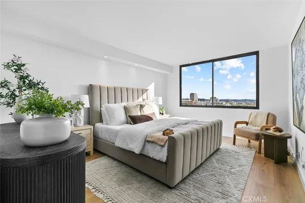 a bedroom with a bed and glass window