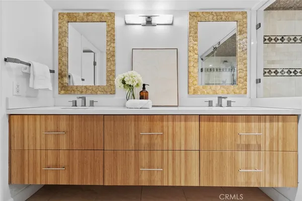 a bathroom with a double vanity sink and mirror