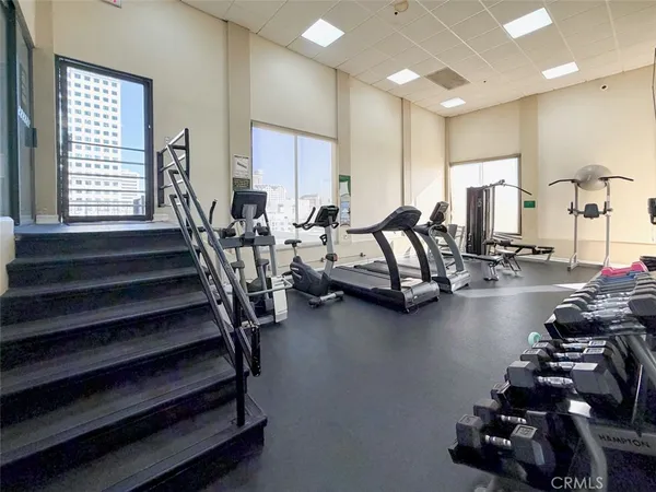 a room with lots of chairs and view of a projector