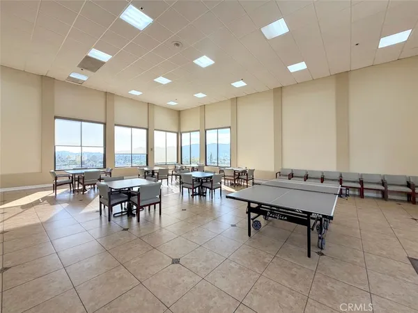 a roof deck with table and chairs