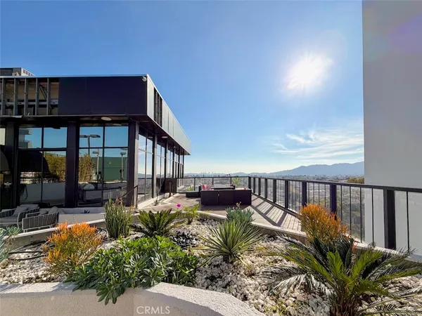 a view of a living room with a table and chairs