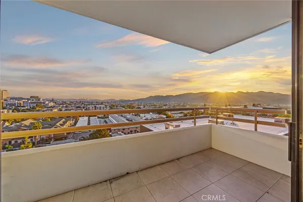 a living room with furniture potted plant a chandelier and a window