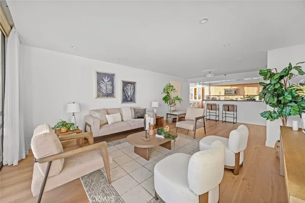 a living room with furniture potted plant and a window