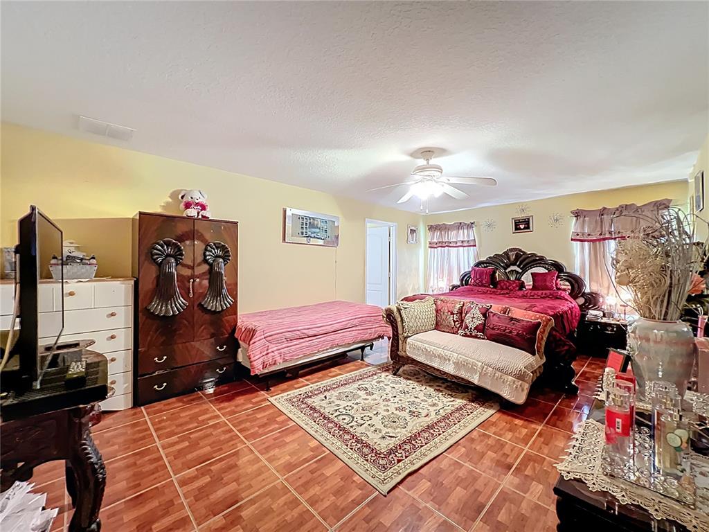 7939 Riffle Lane Orlando, FL 32818 - Photo 25 of 52 a bedroom with furniture and a closet