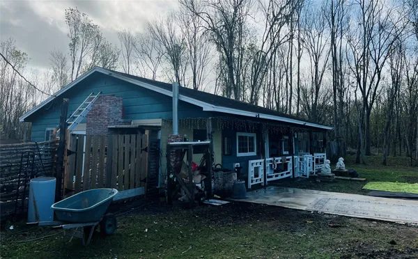 a backyard of a house with barbeque oven and outdoor seating