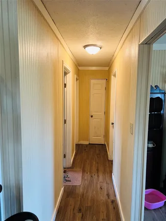 a view of a hallway with wooden floor