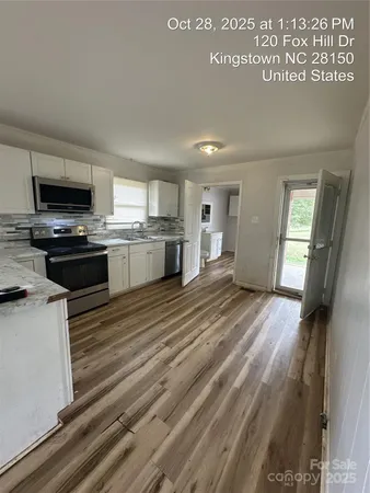 a kitchen with stainless steel appliances granite countertop a stove a sink dishwasher and a refrigerator