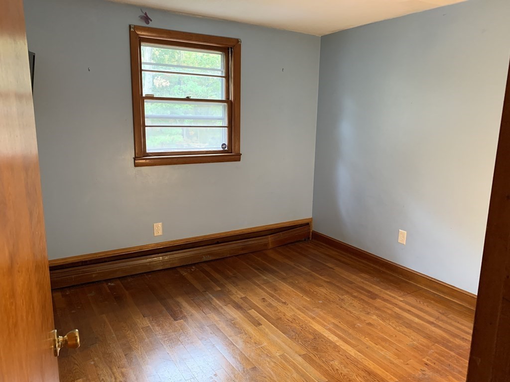 12 Pine Avenue Randolph, MA 02368 - Photo 11 of 18 a view of an empty room with wooden floor and a window