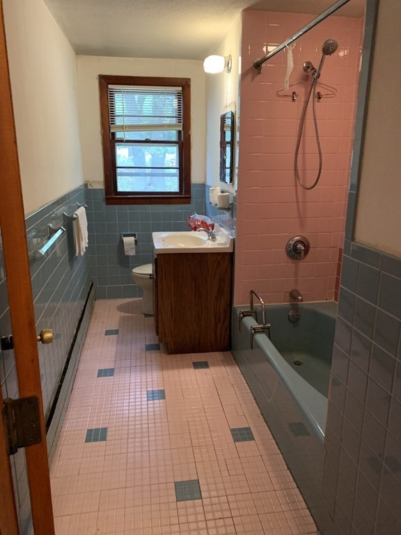 12 Pine Avenue Randolph, MA 02368 - Photo 13 of 18 a bathroom with a tub a sink and glass door shower