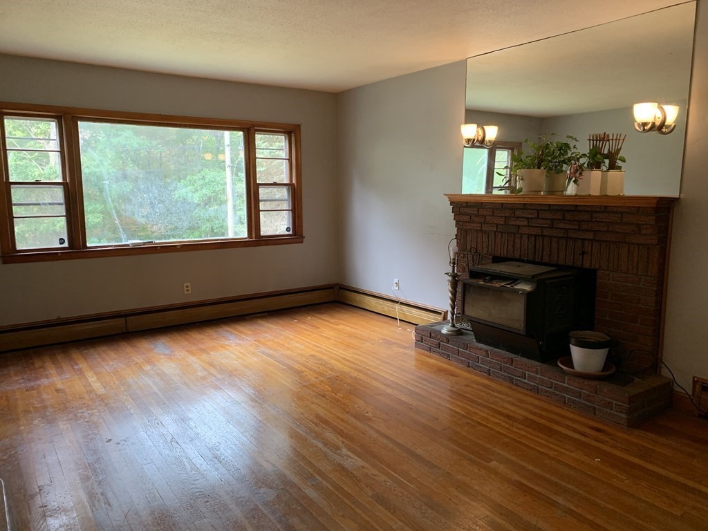 12 Pine Avenue Randolph, MA 02368 - Photo 2 of 18 wooden floor in an empty room with a window