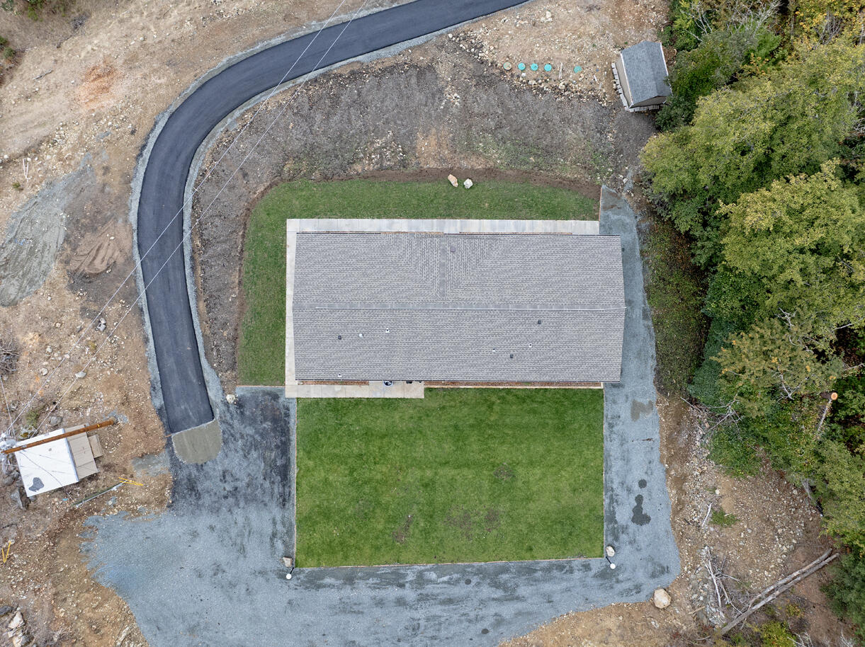5572 Jumpoff Joe Creek Road Grants Pass, OR 97526 - Photo 22 of 38 a stone house with a yard in front of it