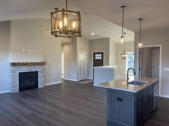 14168 Prairie Commons Lane South Beloit, IL 61080 - Photo 2 of 15 a kitchen with kitchen island granite countertop wooden floor a refrigerator and a fireplace