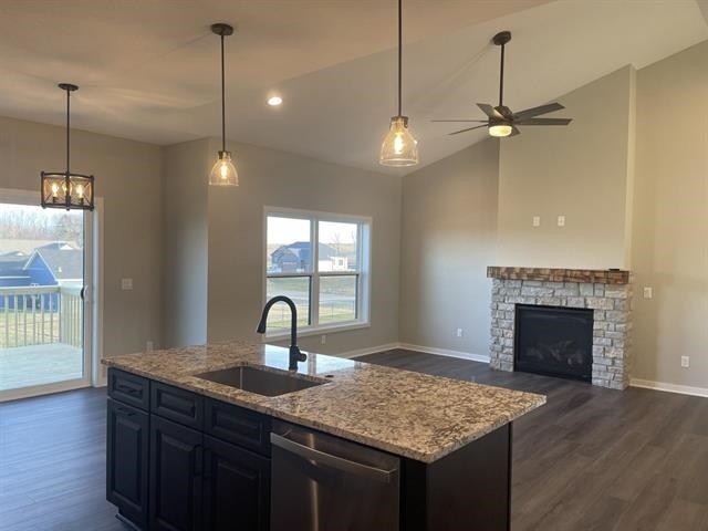 14168 Prairie Commons Lane South Beloit, IL 61080 - Photo 8 of 15 a kitchen with kitchen island a counter space a sink appliances and a wooden floor