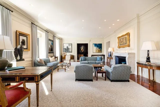 a white building with glass top table and chairs