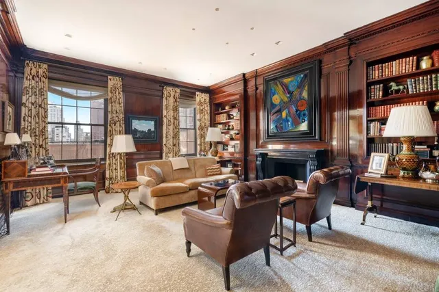a living room with fireplace furniture and a flat screen tv