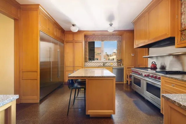 a kitchen with kitchen island a sink appliances and cabinets