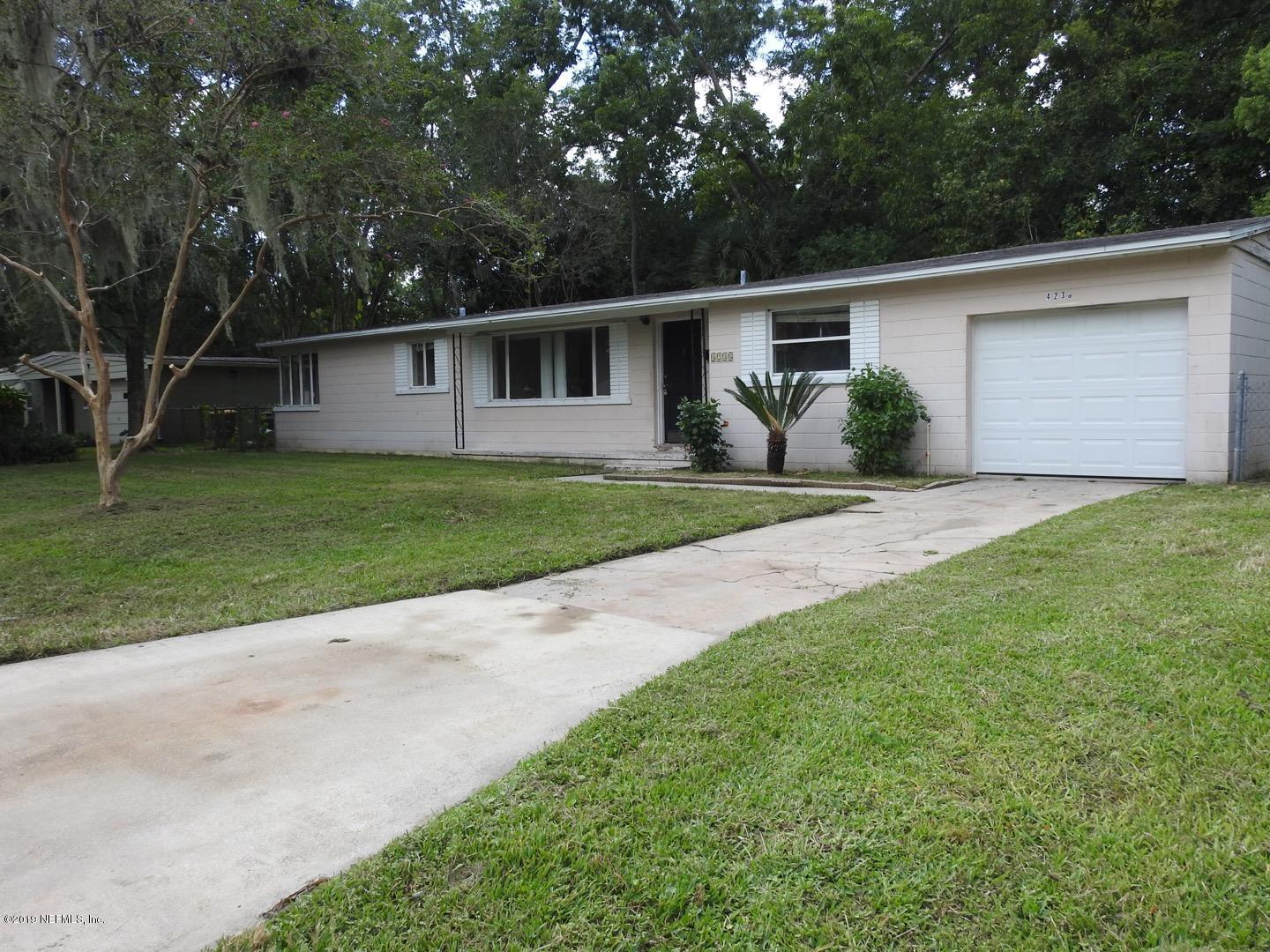 4238 Springwood Road Jacksonville, FL 32207 - Photo 1 of 19 a front view of a house with a yard and garage