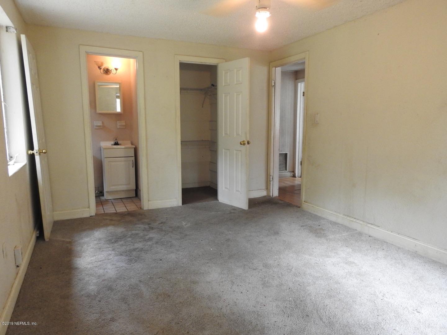 4238 Springwood Road Jacksonville, FL 32207 - Photo 11 of 19 an empty room with windows and bathroom