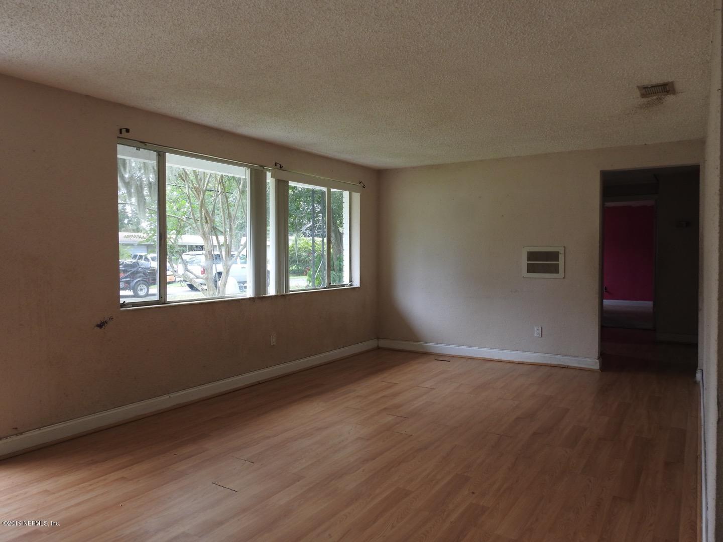 4238 Springwood Road Jacksonville, FL 32207 - Photo 15 of 19 a view of an empty room with wooden floor and a window