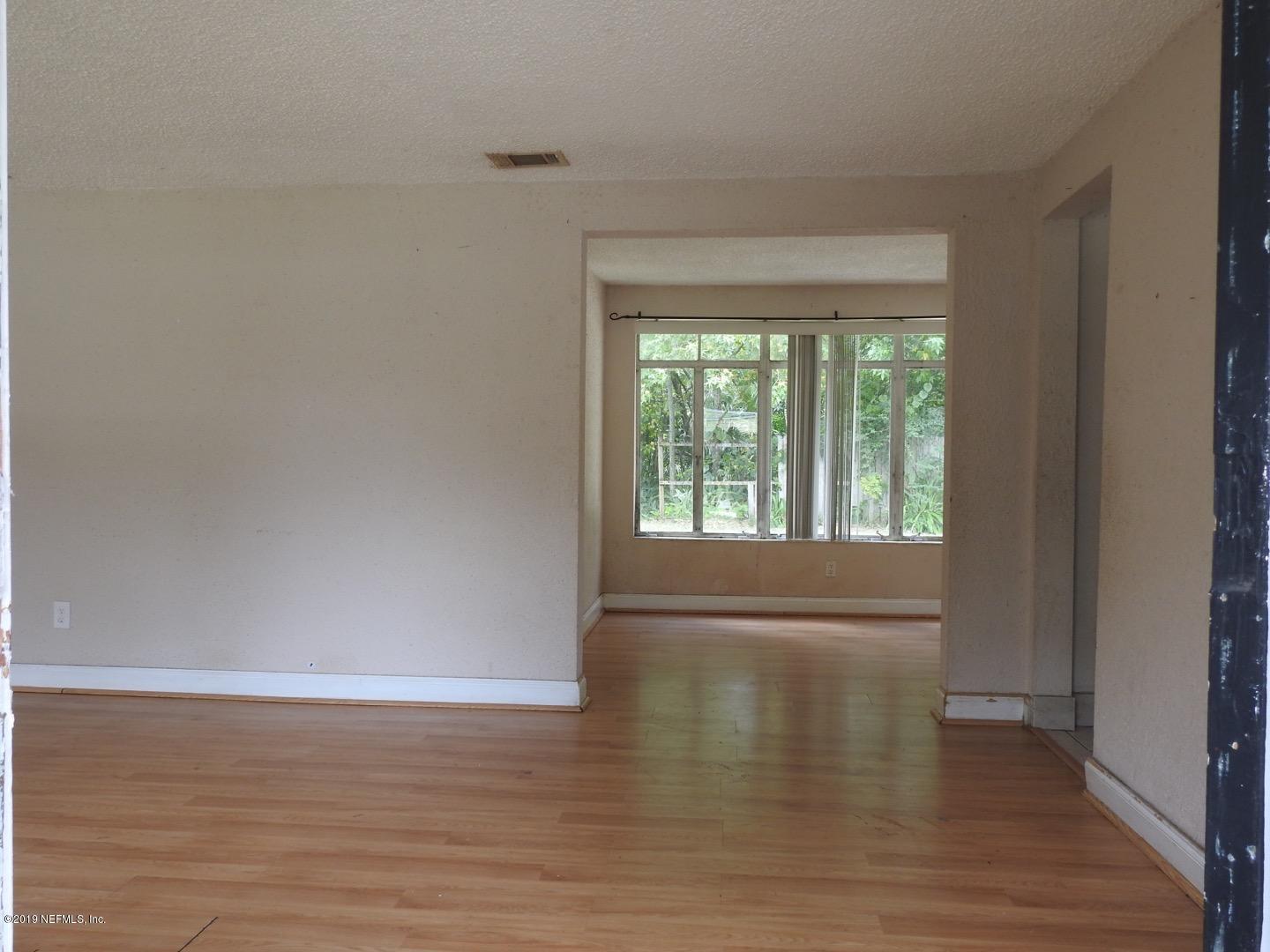 4238 Springwood Road Jacksonville, FL 32207 - Photo 17 of 19 a view of empty room with wooden floor and fan
