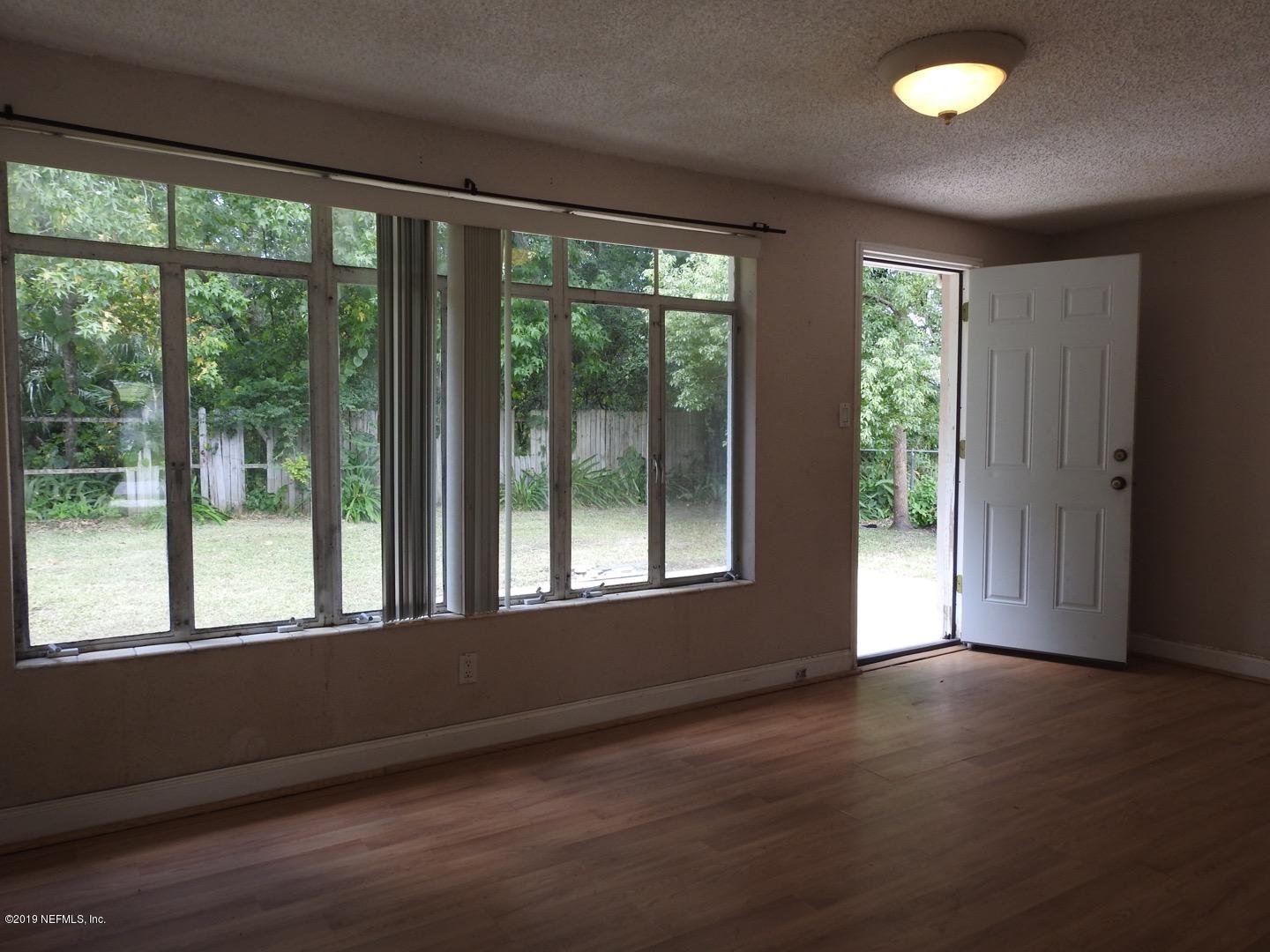 4238 Springwood Road Jacksonville, FL 32207 - Photo 19 of 19 a view of an empty room with wooden floor and a window