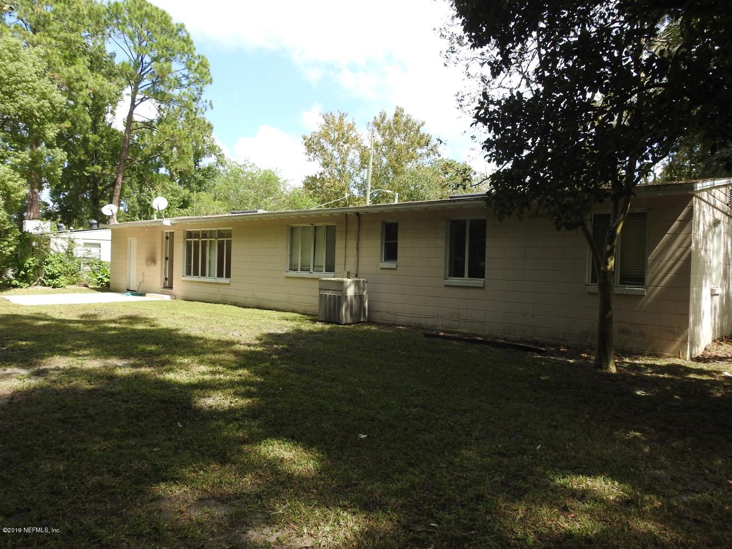 4238 Springwood Road Jacksonville, FL 32207 - Photo 5 of 19 a backyard of a house with table and chairs