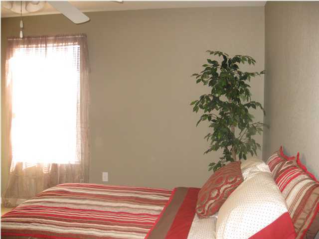 305 Seclusion Boulevard Crestview, FL 32536 - Photo 11 of 12 a bedroom with a bed and a potted plant