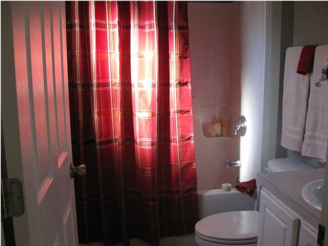 305 Seclusion Boulevard Crestview, FL 32536 - Photo 12 of 12 a bathroom with a toilet and shower curtain