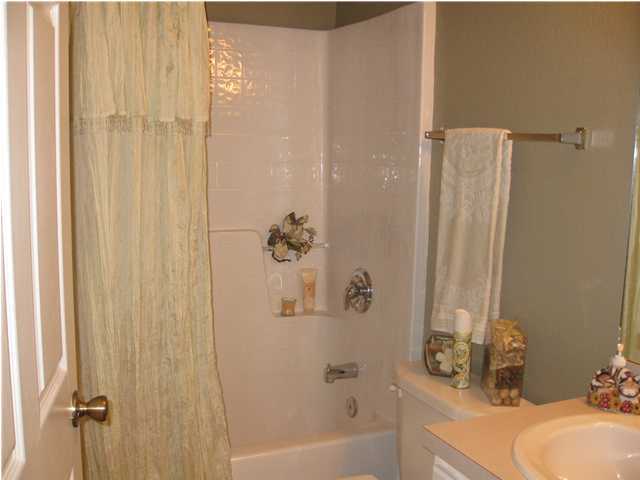 305 Seclusion Boulevard Crestview, FL 32536 - Photo 9 of 12 a bathroom with a sink and a shower curtain