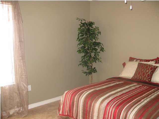 305 Seclusion Boulevard Crestview, FL 32536 - Photo 10 of 12 a bedroom with a bed and a plant