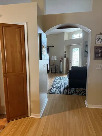 a bedroom with a bed and a lamp on the dresser