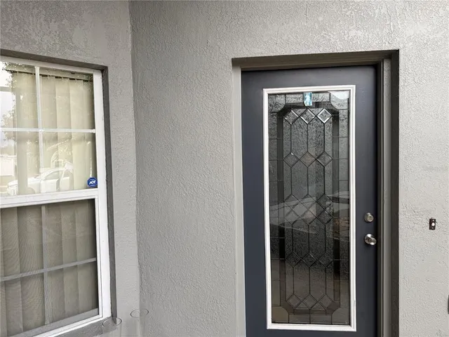 a view of a hallway with a wooden door