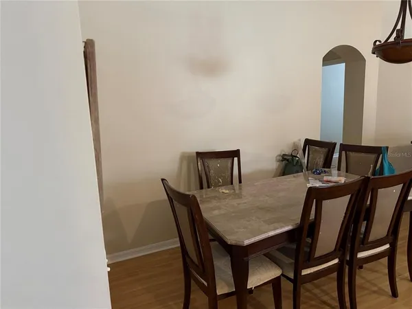 a view of a dining room with furniture and a mirror