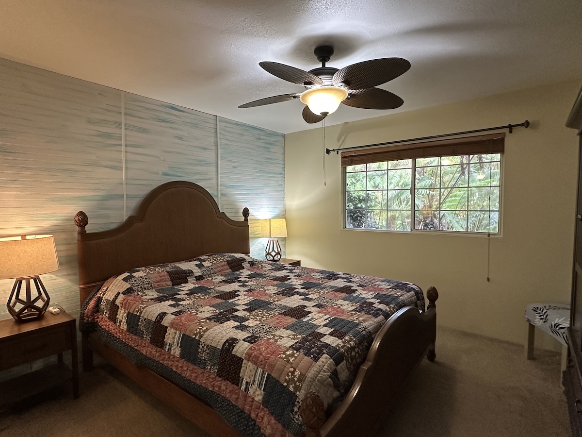 19-4157 Wright Road Volcano, HI 96785 - Photo 8 of 16 a bedroom with a bed and a chandelier