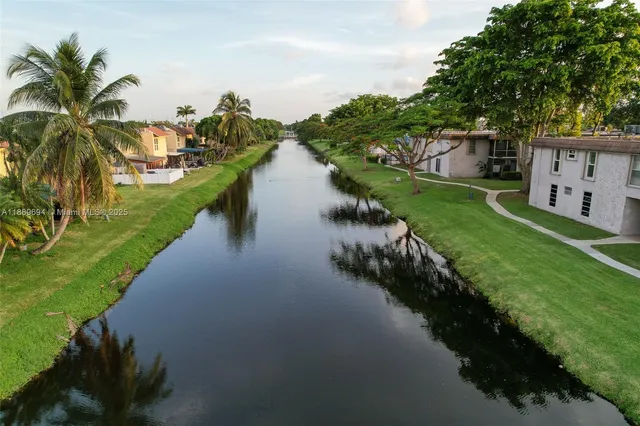 a view of a lake with a yard and mountain