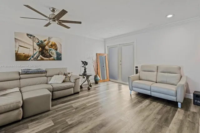 a living room with furniture and a ceiling fan