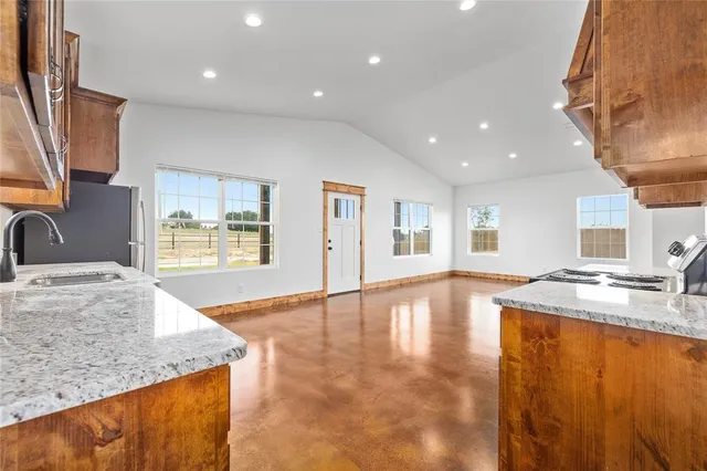 a view of a kitchen with a sink and a large window