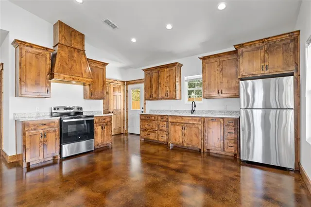a large kitchen with cabinets and stainless steel appliances