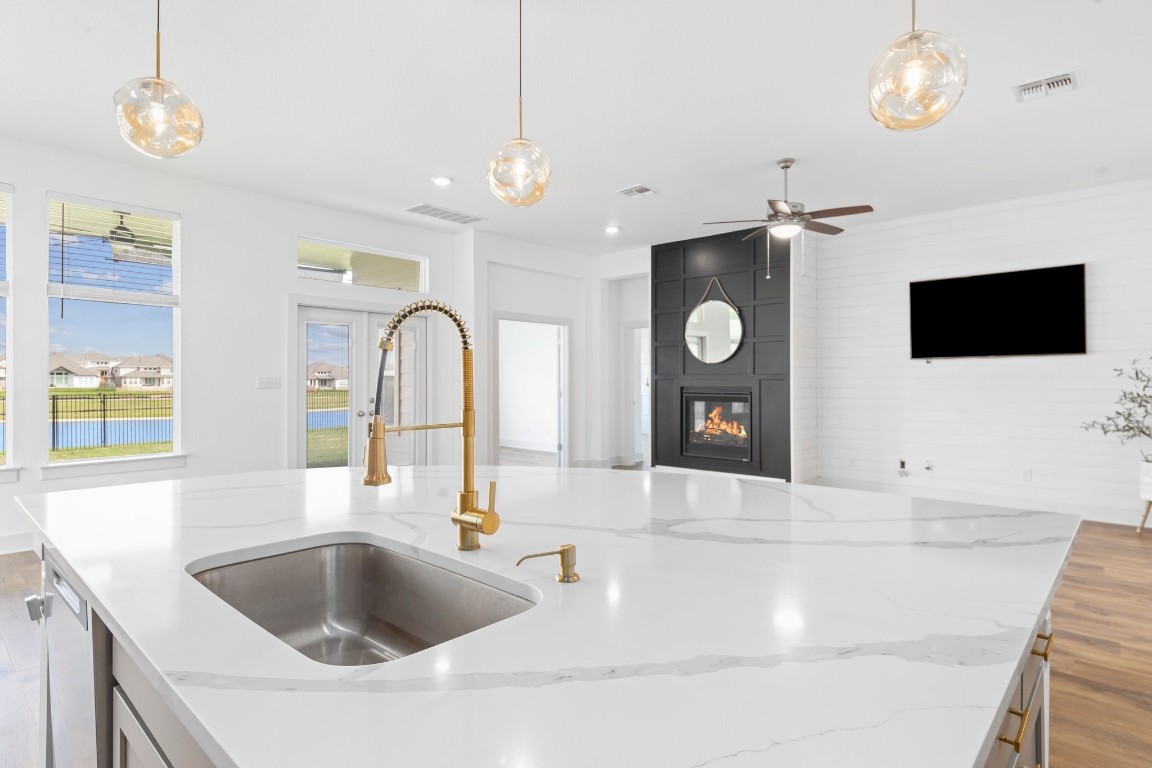 a kitchen with a sink and a chandelier