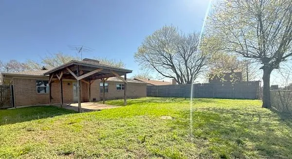 a view of a house with a yard and garage