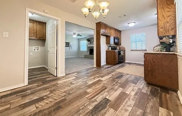 a view of a kitchen with a sink and a refrigerator