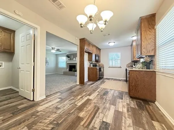 a view of a kitchen with furniture and a chandelier