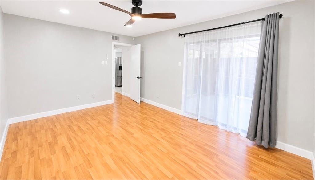 15889 Preston Road, Unit 1004 Dallas, TX 75248 - Photo 14 of 17 a view of a big room with wooden floor and windows in a room