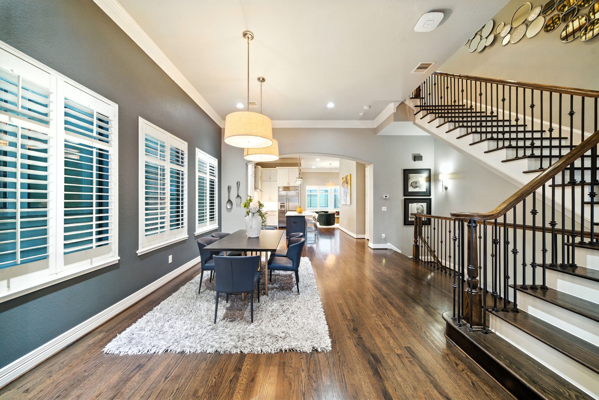 803 Bomar Street, Unit A Houston, TX 77006 - Photo 13 of 39 a dining room with wooden floor a chandelier a wooden table and chairs