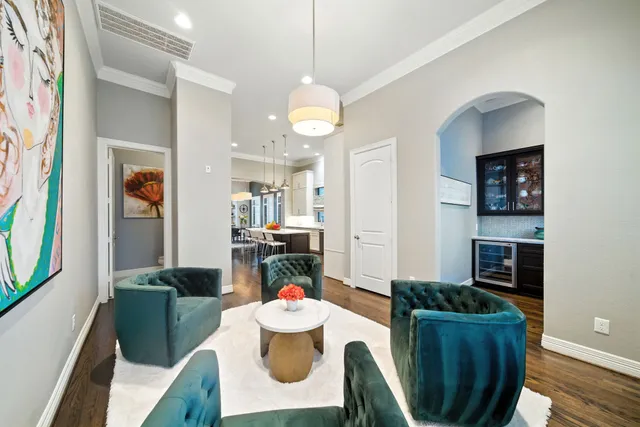 a view of a dining room with furniture a chandelier and wooden floor