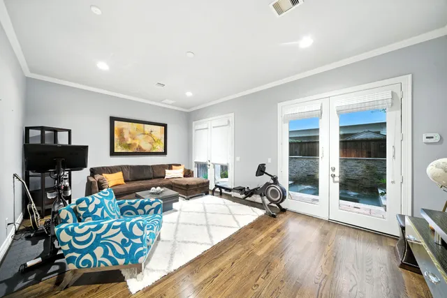 a living room with furniture and a floor to ceiling window