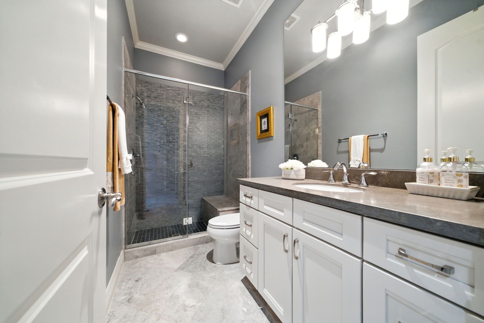 803 Bomar Street, Unit A Houston, TX 77006 - Photo 31 of 39 a bathroom with a double vanity sink toilet mirror and shower