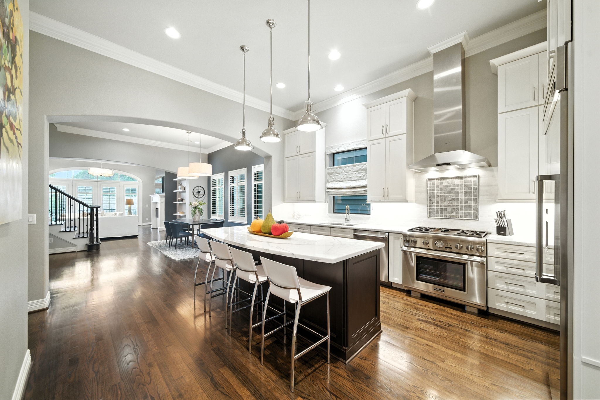 803 Bomar Street, Unit A Houston, TX 77006 - Photo 4 of 39 a kitchen with stainless steel appliances a stove a sink dishwasher a refrigerator and white cabinets with wooden floor