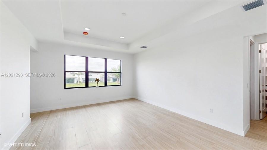 8350 Royal County Down Road Boca Raton, FL 33434 - Photo 19 of 52 an empty room with wooden floor and windows